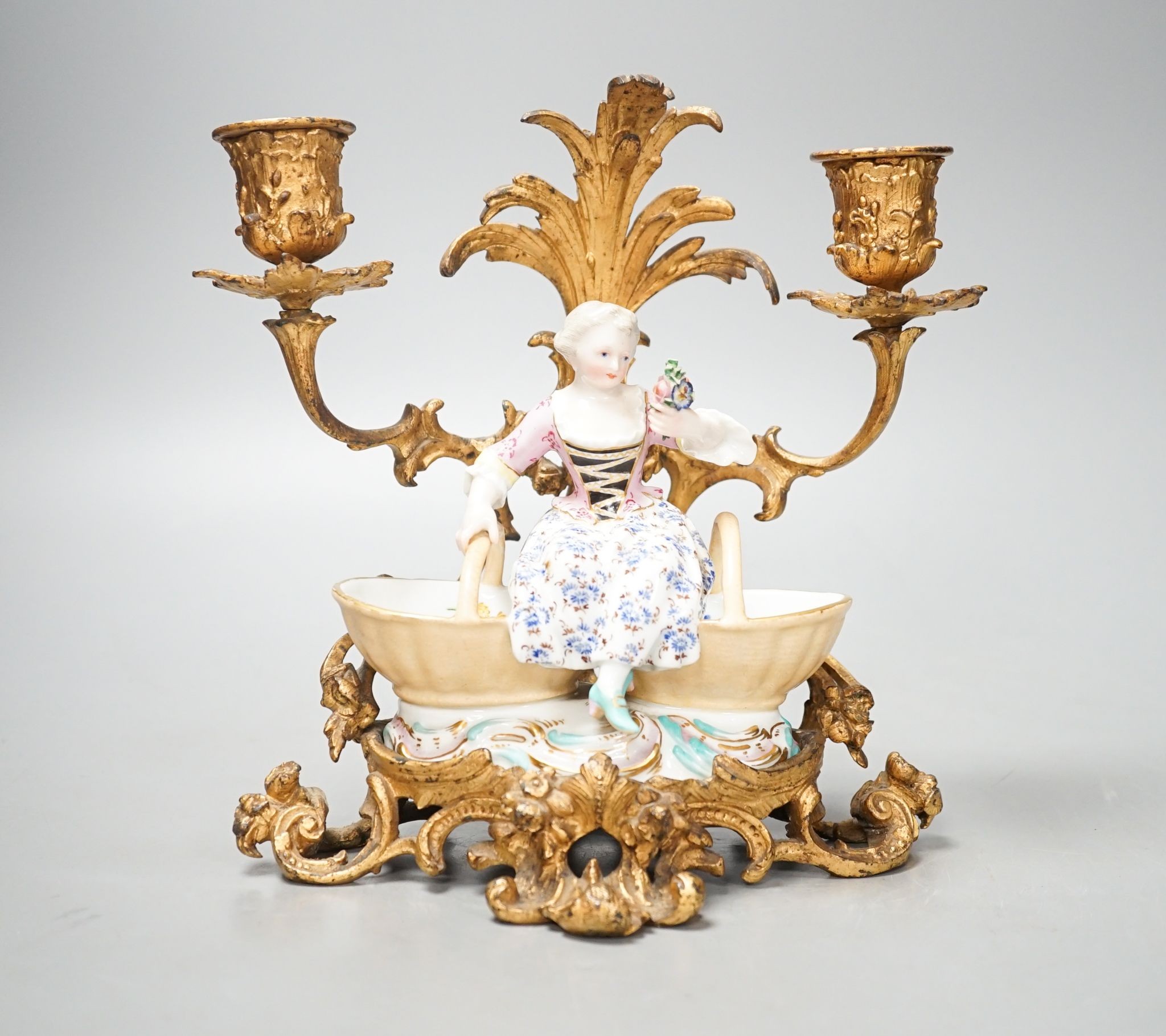 A 19th century Meissen figural salt, incised number 3024, on ormolu candle stand. Total height - 21cm